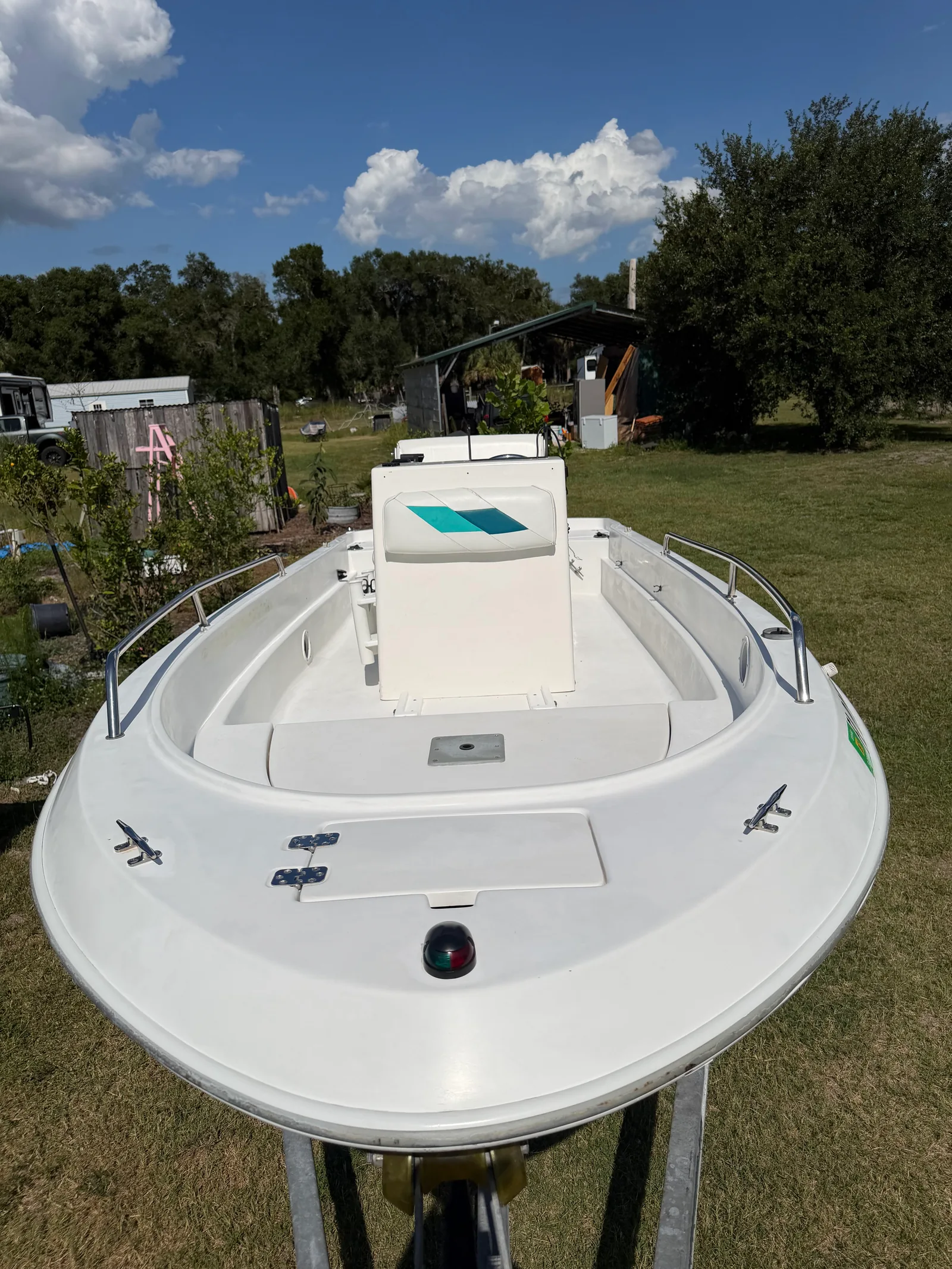 White bow deck and center console with teal-trimmed seating