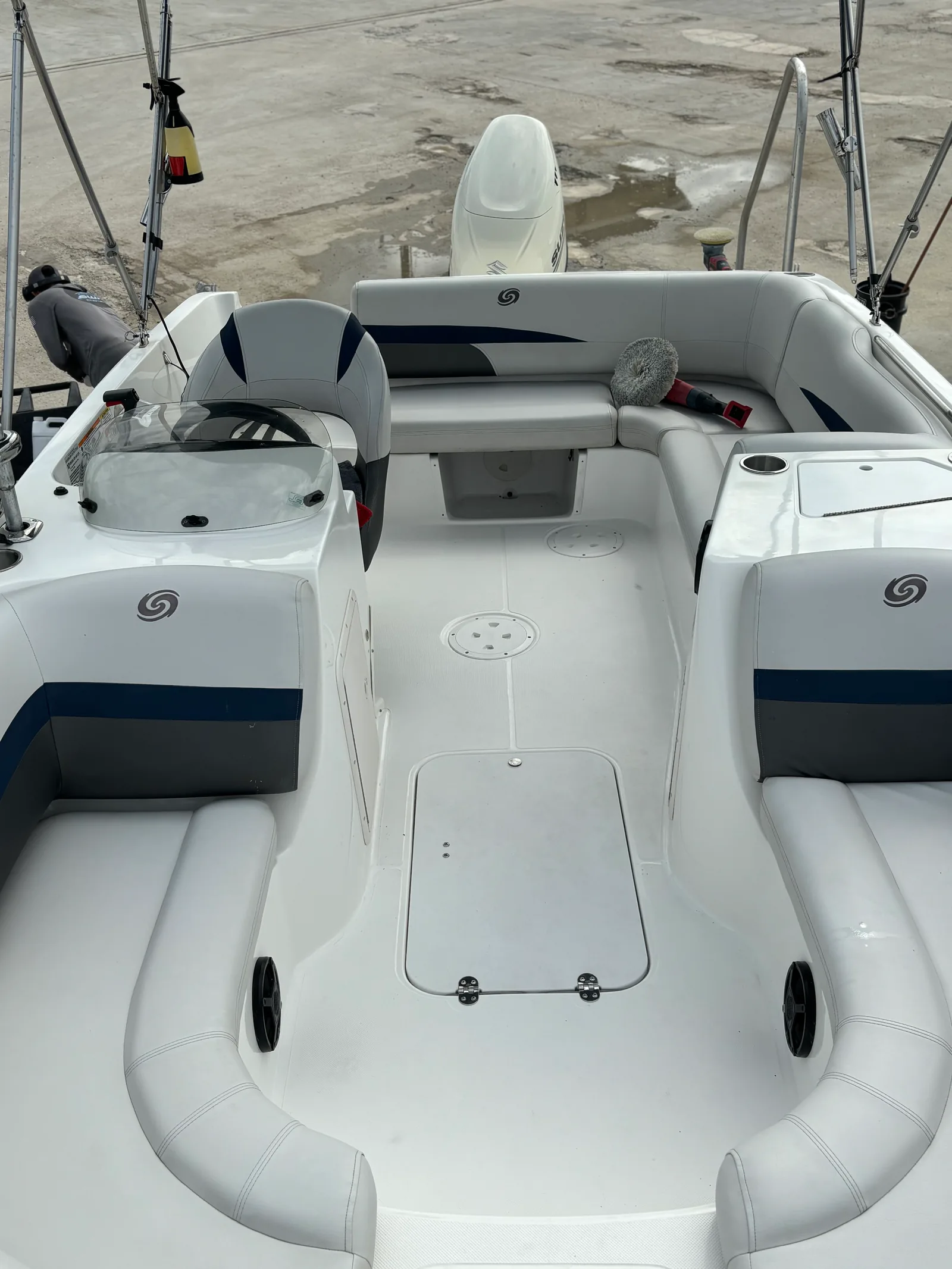 Boat cockpit with white and navy upholstery and detailing tools