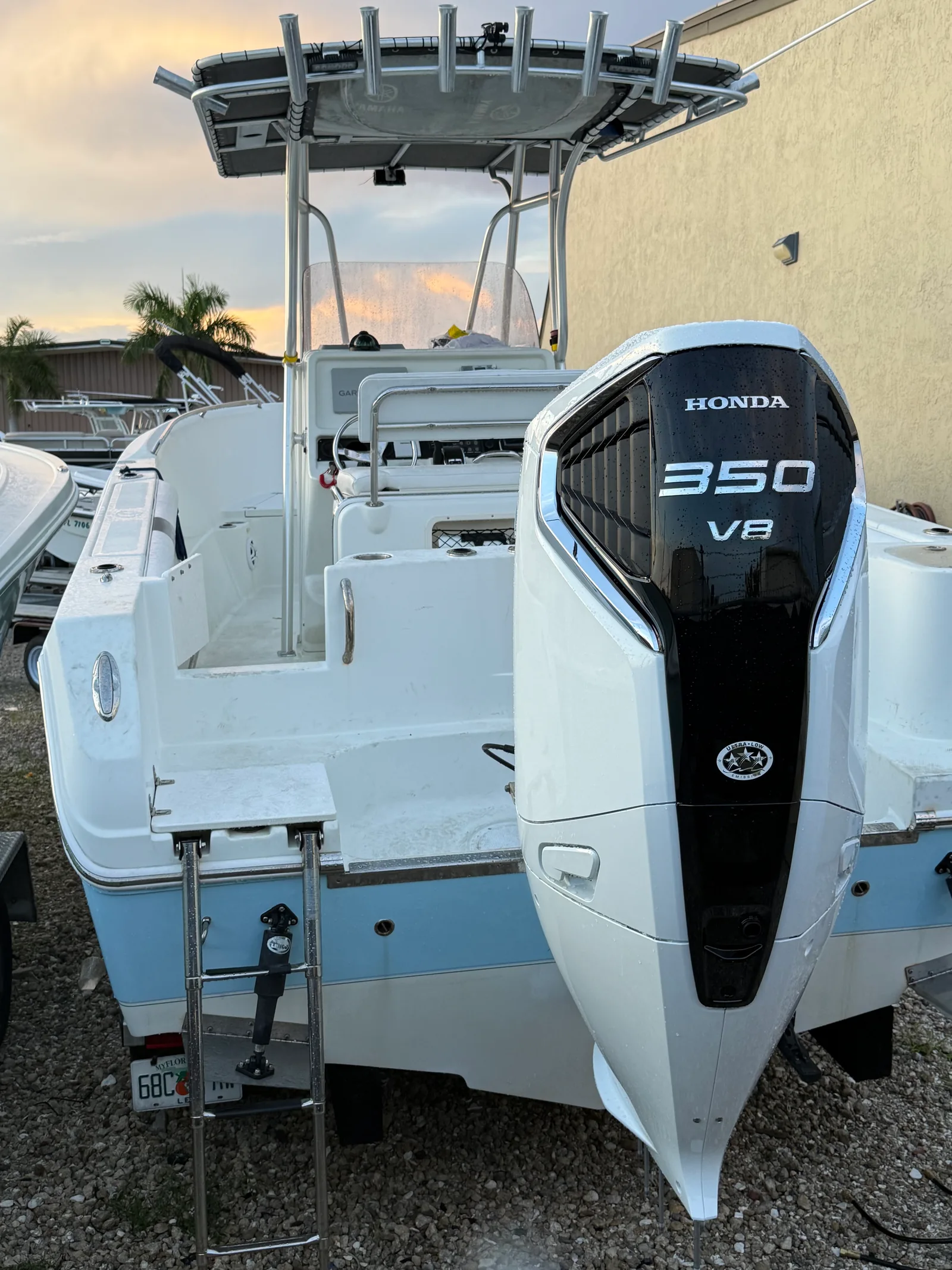 Outboard motor and stern during a boat wash at sunset