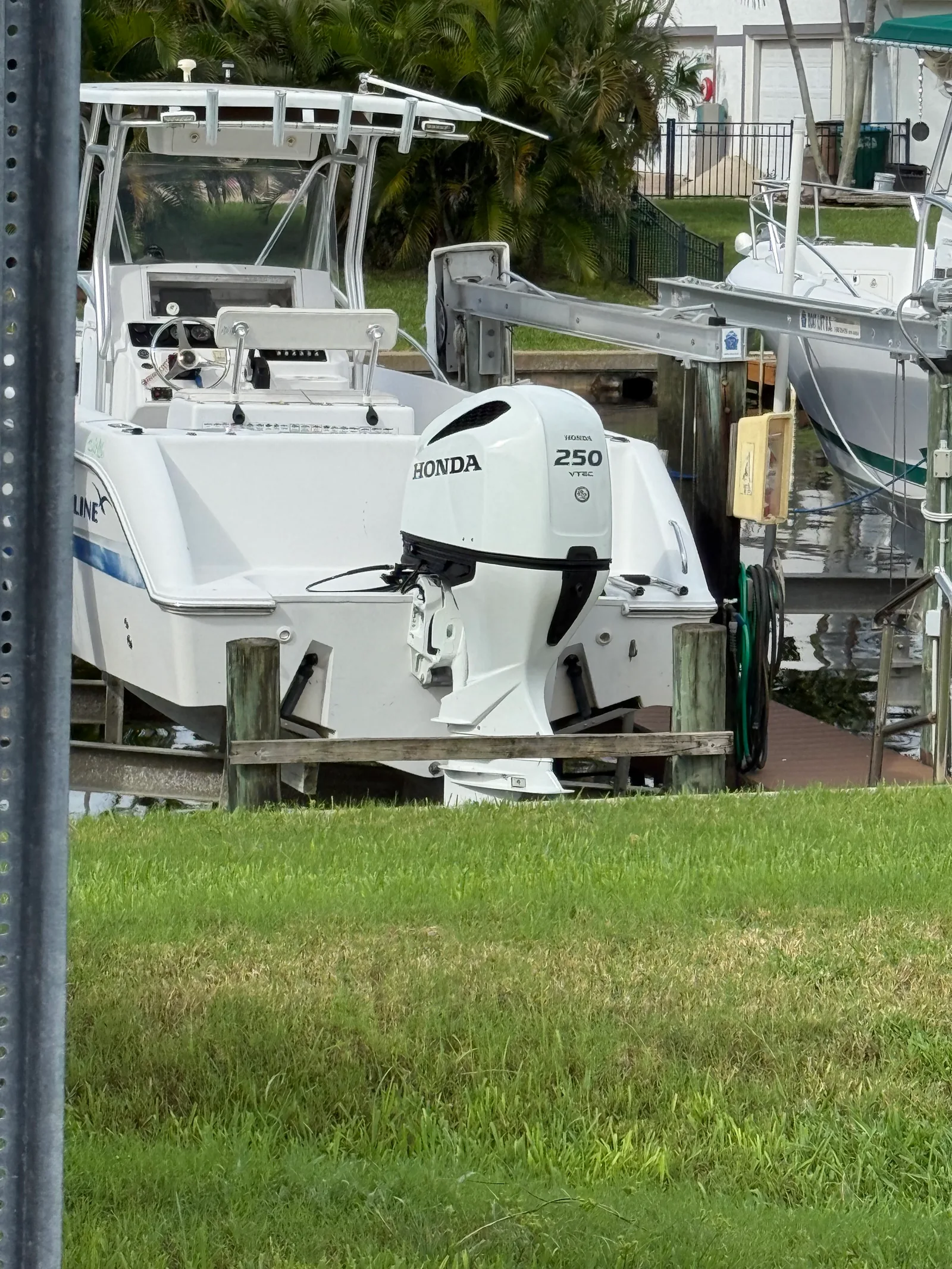 White boat and outboard motor at a residential dock