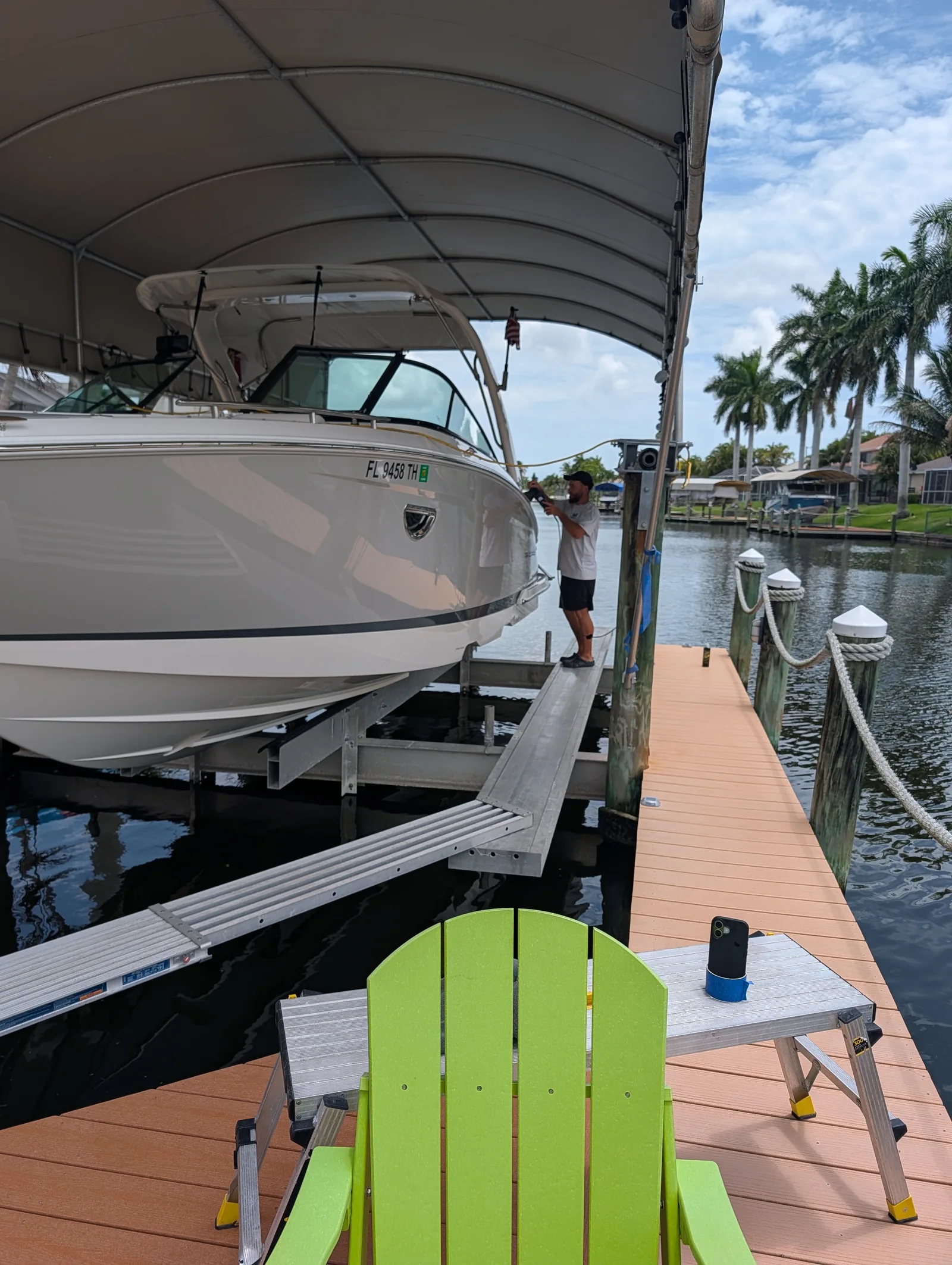 Marine detailing in progress on a boat at a covered dock